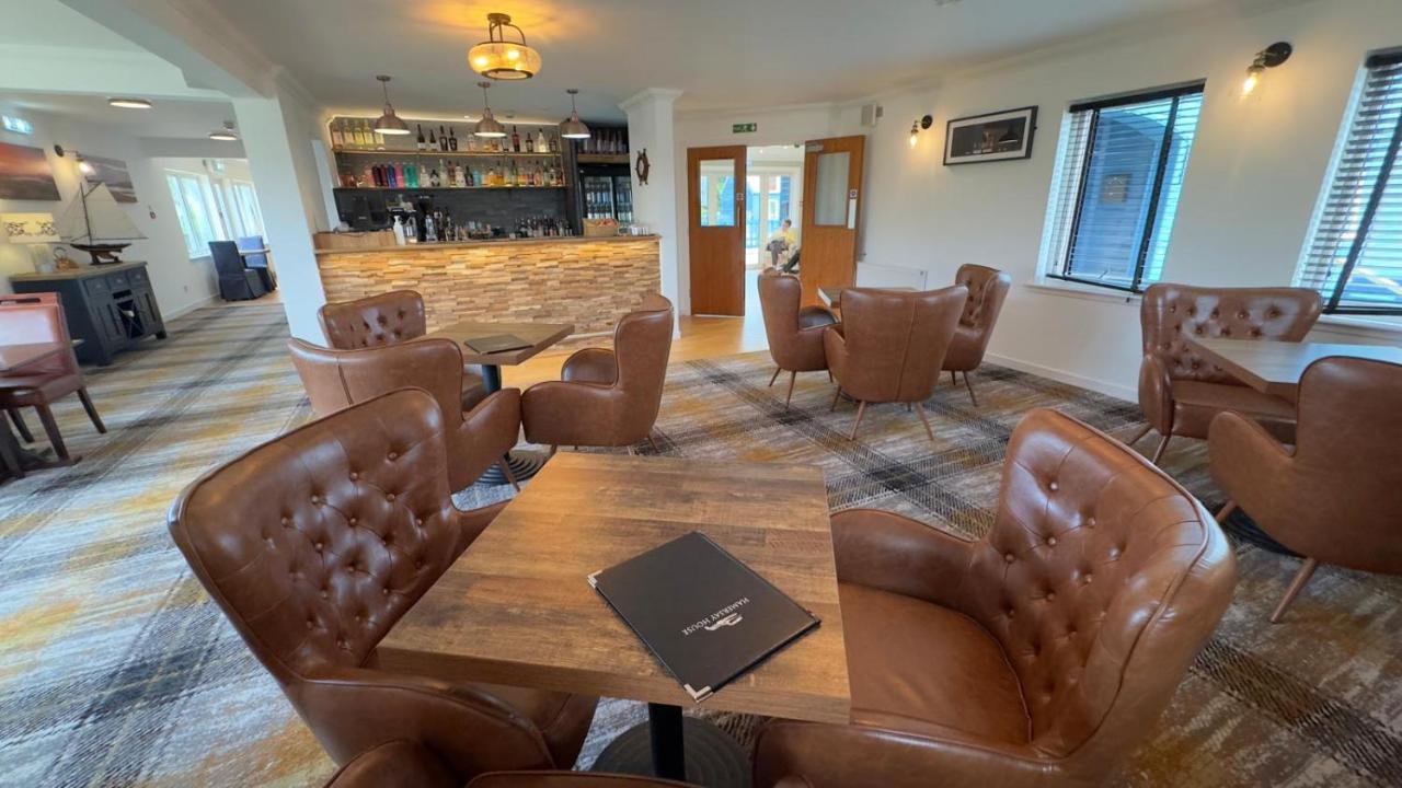 Restaurant and bar area with dining tables at Hamersay Hotel